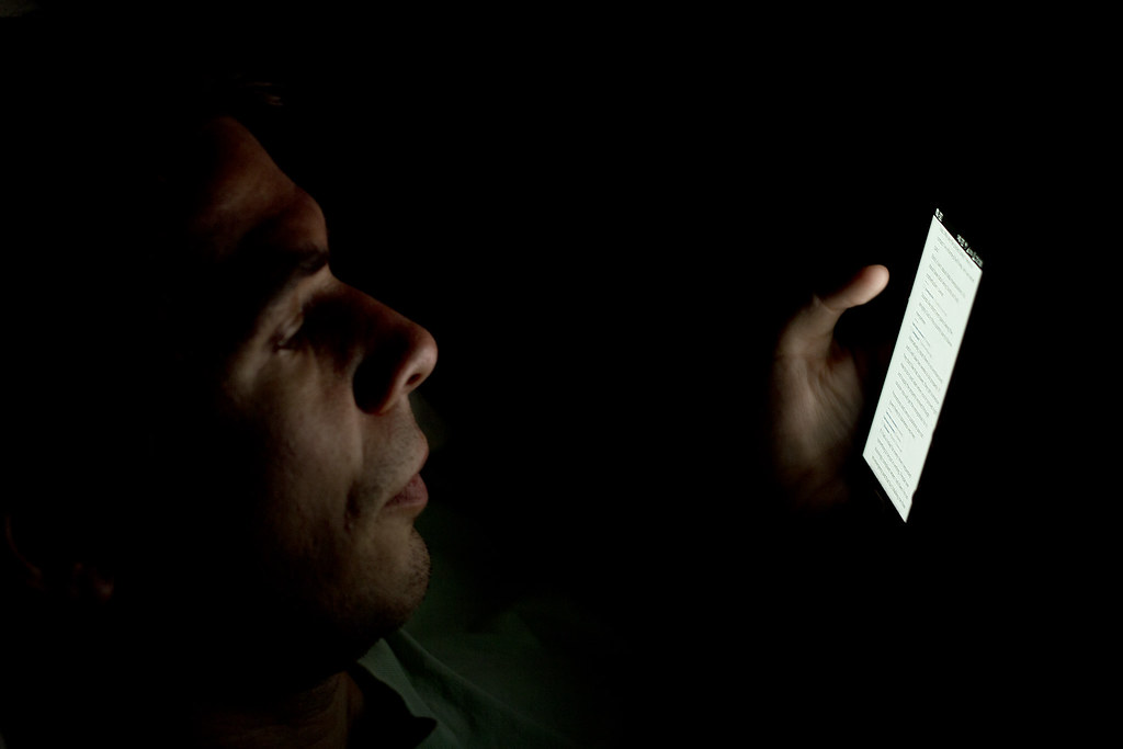 Person looking at a smartphone screen in the dark