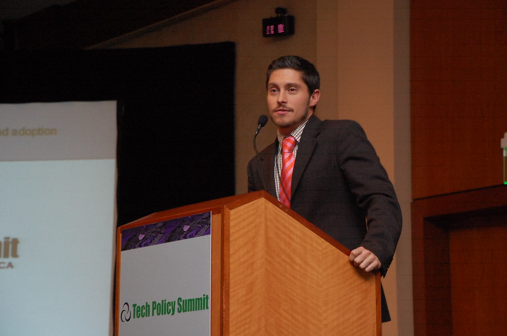 Speaker at a Tech Policy Summit podium